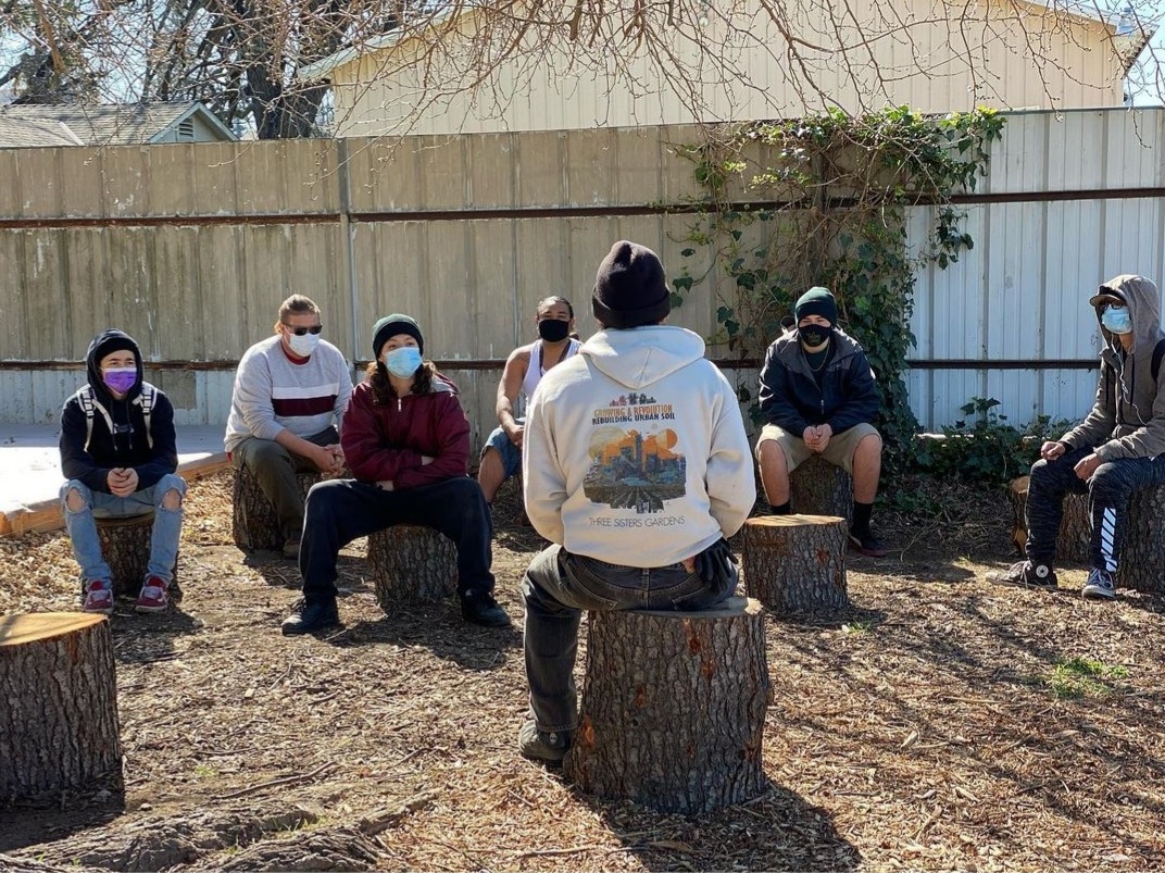 Volunteers sitting around in a circle